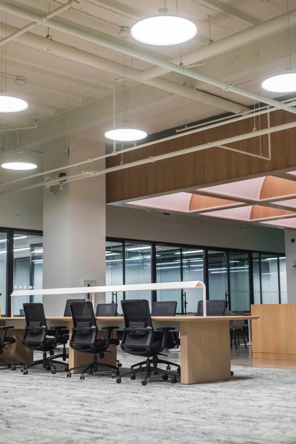 Shared office work table with chairs and pendant lighting